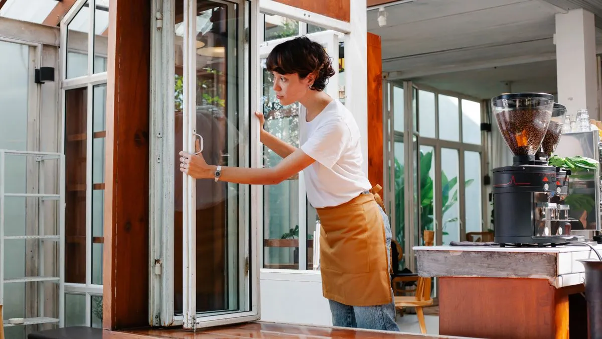 Cafe worker opening the shop, a job commonly paid Alberta minimum wage
