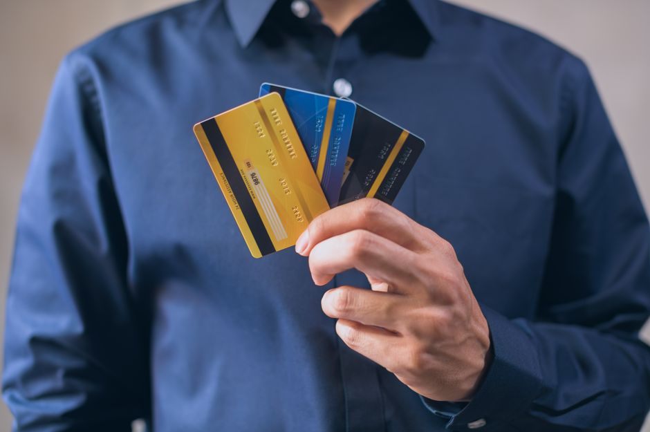 Person holding credit cards representing bad credit borrowing options in Canada