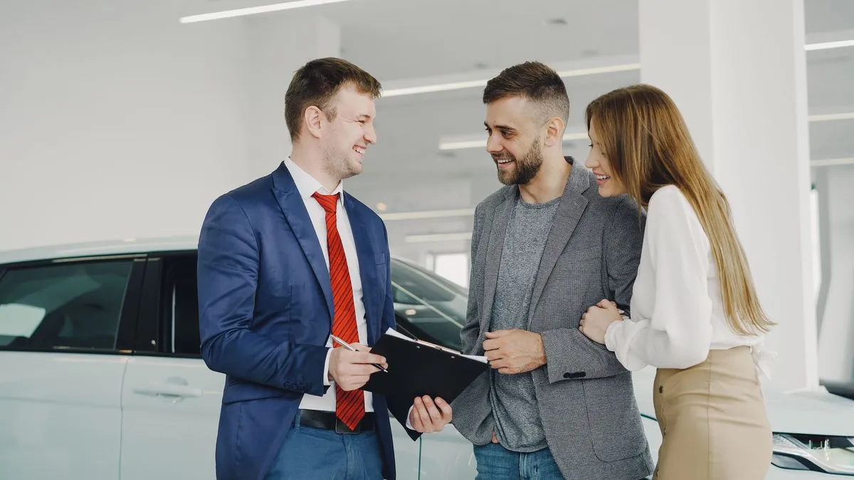 Couple arranging car financing at a Canadian dealership