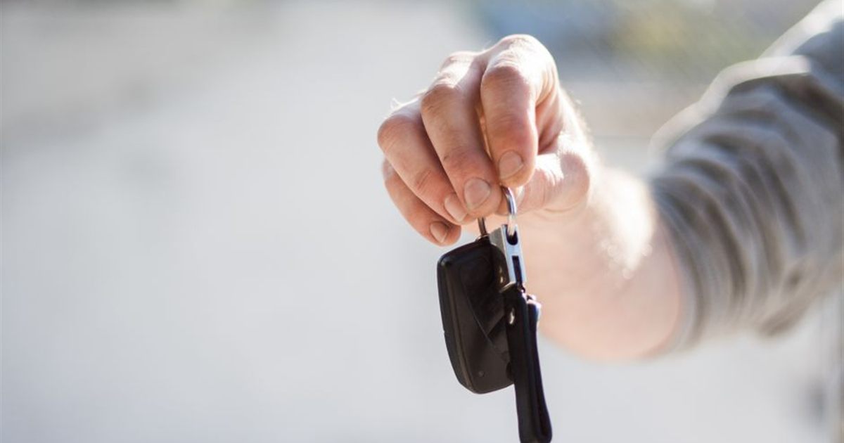 Hand holding car keys representing car financing in Canada