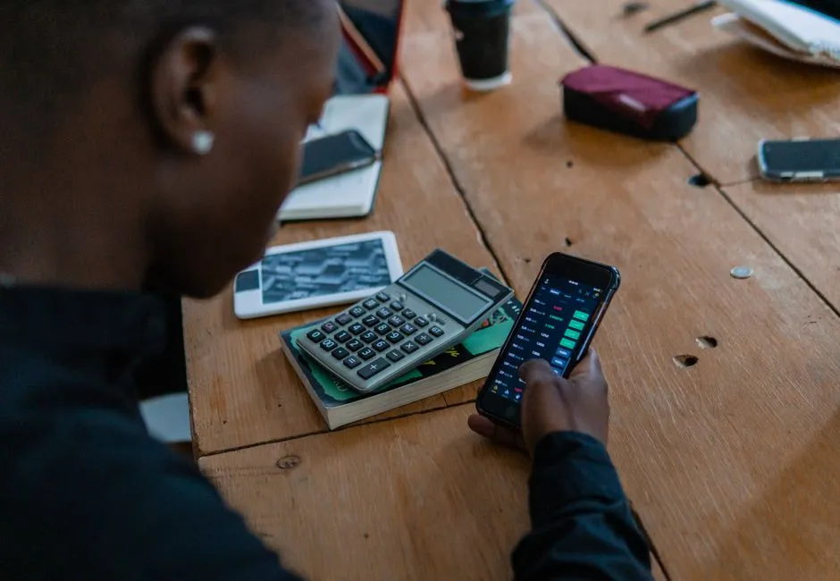 Person checking financial information on a phone to monitor a credit score