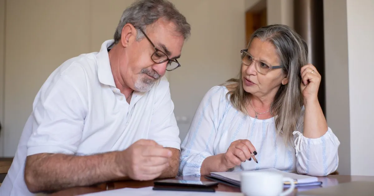Senior Canadian couple reviewing CPP payment dates 2026 at their kitchen table
