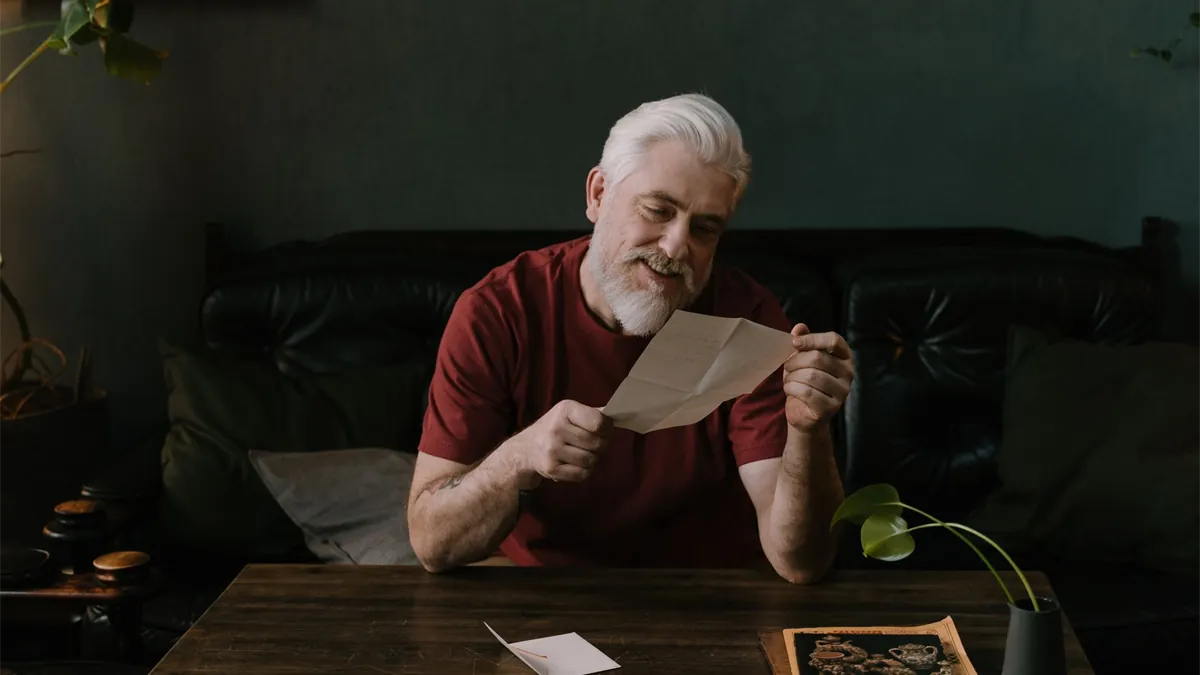 Older Canadian man reading an Old Age Security letter to check GIS eligibility before the next GIS payment dates