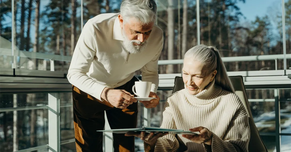 Senior Canadian couple reviewing their 2026 GIS payment dates in a bright home
