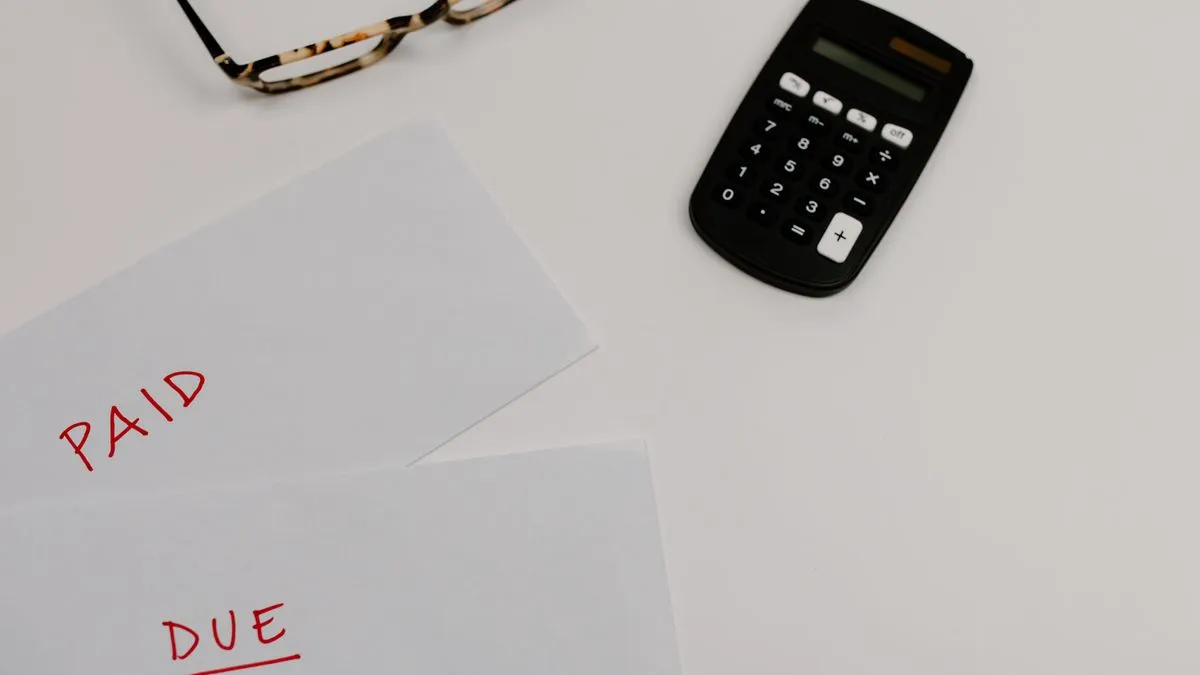 Paid bills showing progress on how to get out of debt in Canada