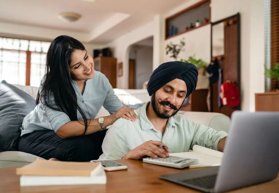 Canadian couple reviewing finances at home to improve their credit scores