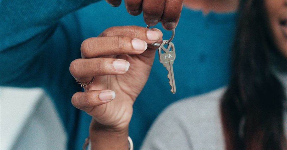 Couple receiving house keys representing a mortgage in Canada