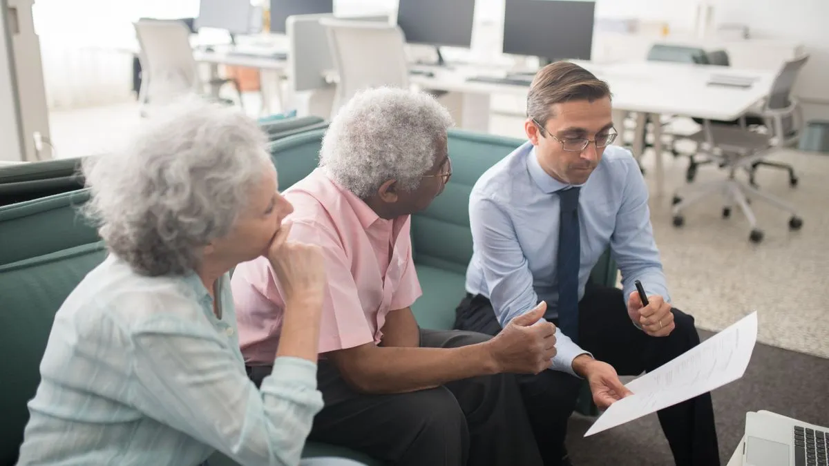 Advisor explaining OAS eligibility to a senior couple in Canada