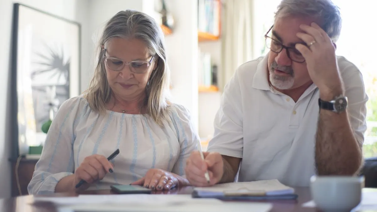 Senior couple calculating their 2026 OAS payment amount at home