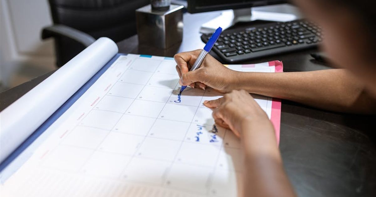 Planning monthly payment dates on a desk calendar