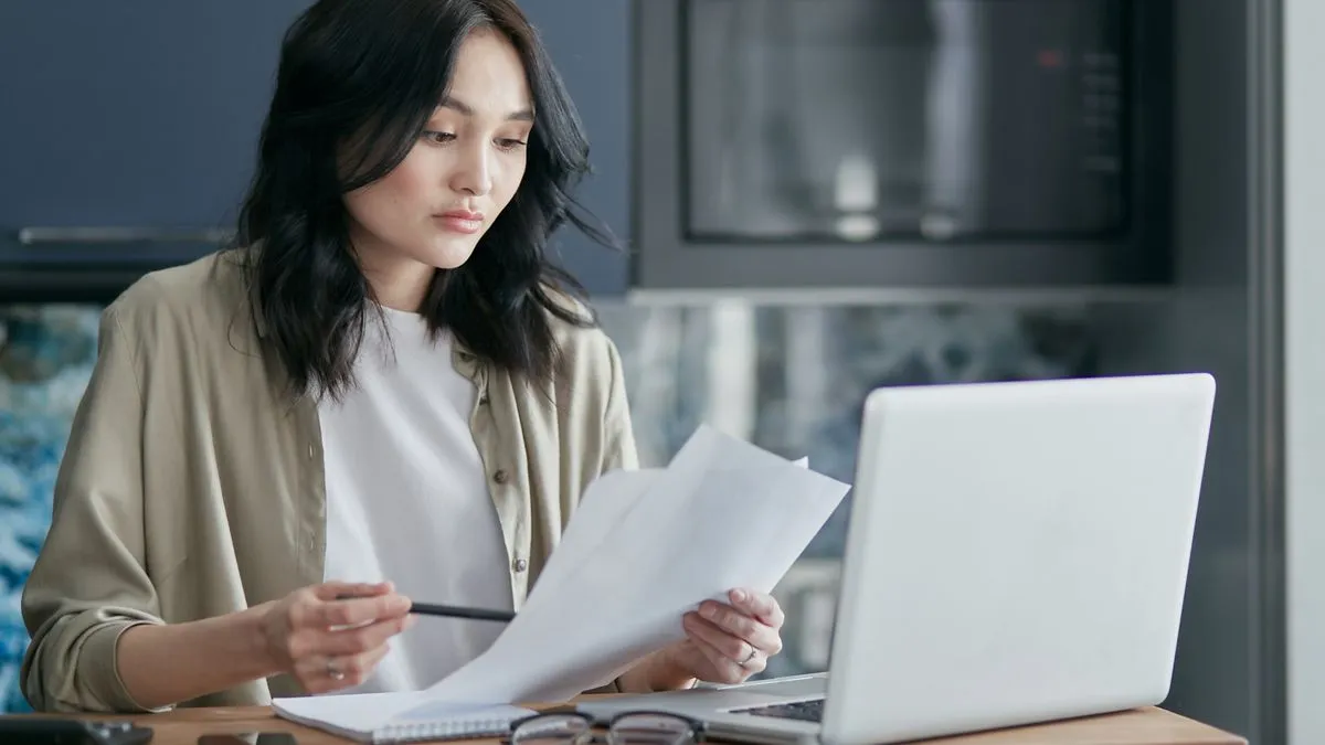 Woman reviewing the documents needed to apply for a SIN in Canada
