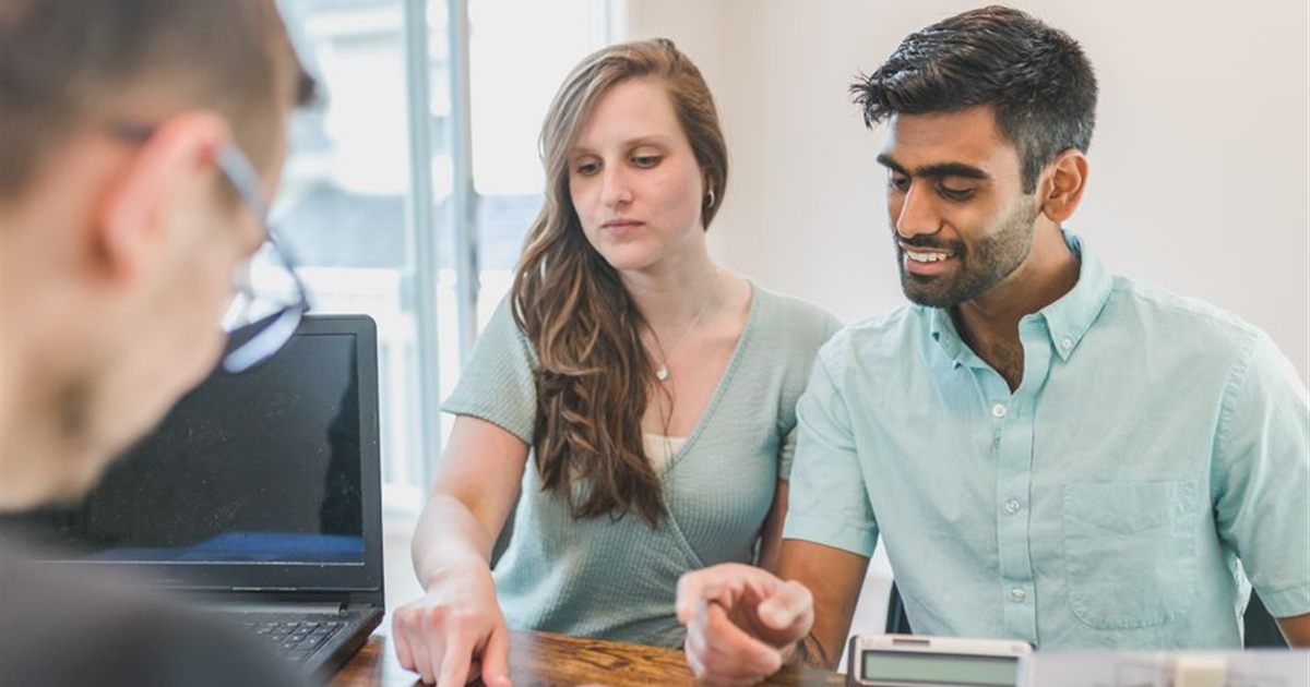 Canadians reviewing money options with a financial advisor at The Finance Guys