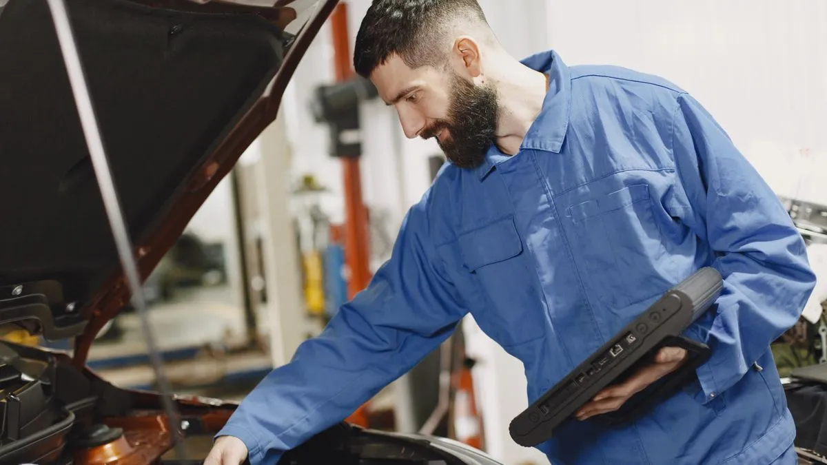 Mechanic inspecting a used car before financing in Canada