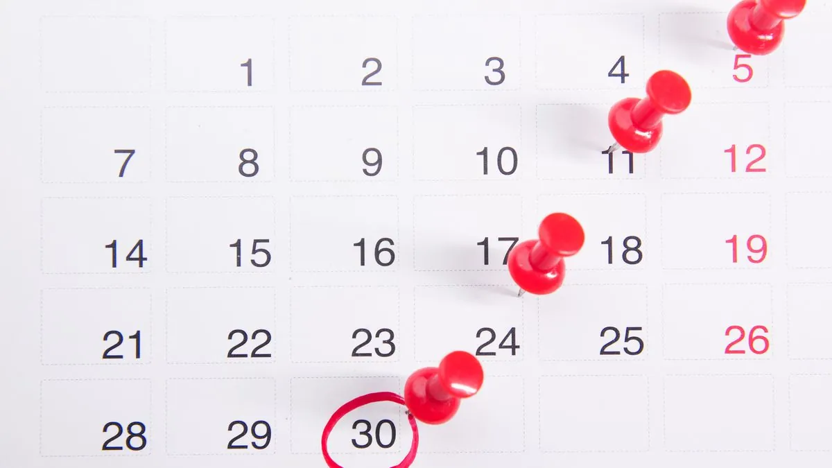Calendar with pinned and circled dates marking monthly benefit payment dates