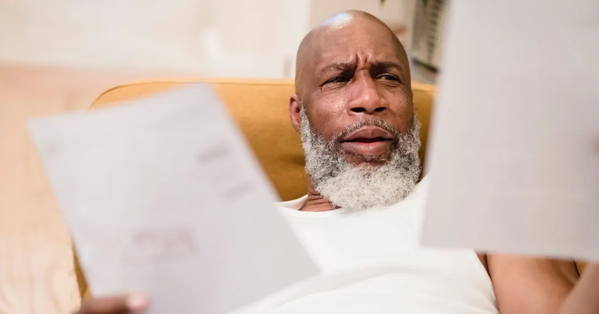 Man reviewing bills and weighing a payday loan repayment