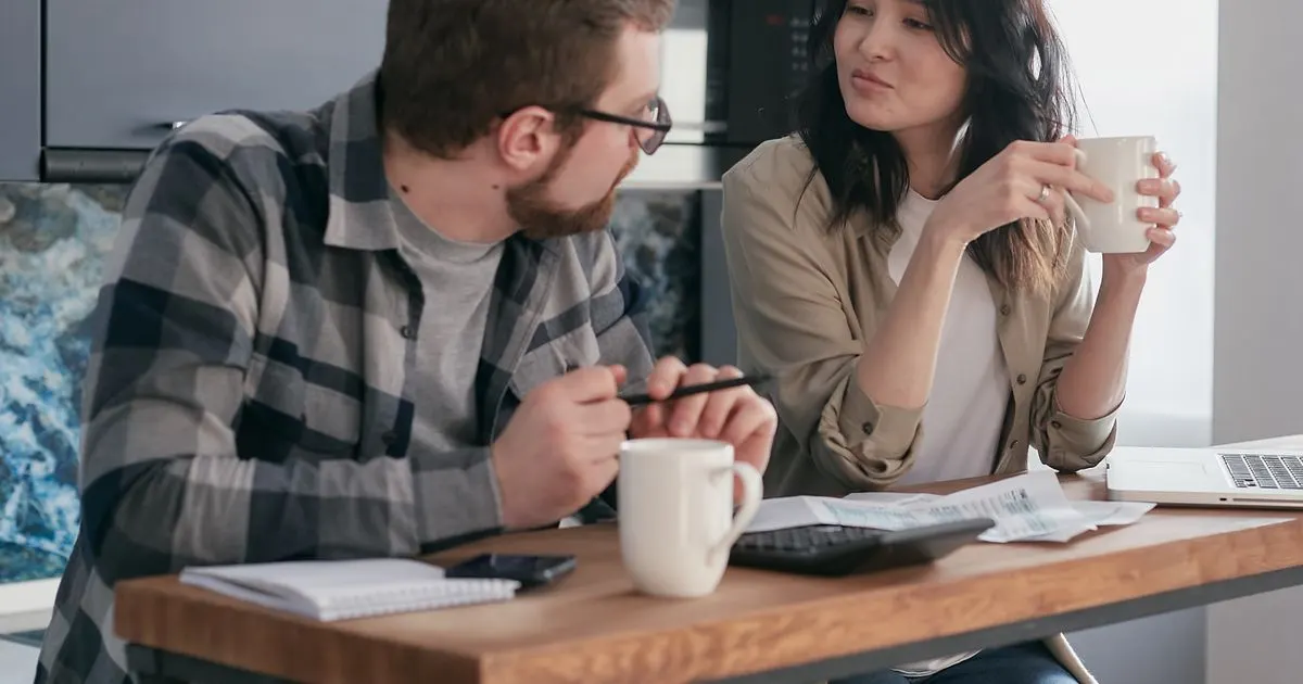 Couple weighing a payday loan vs installment loan at their kitchen table