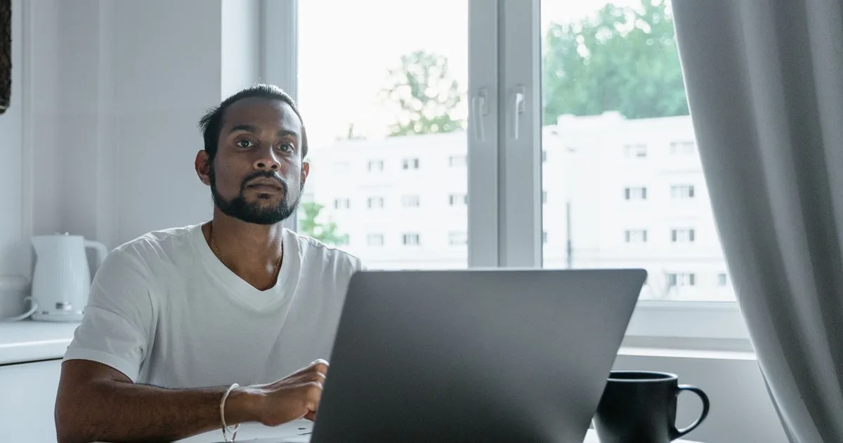 Ontario resident preparing to apply for ODSP online with documents beside a laptop