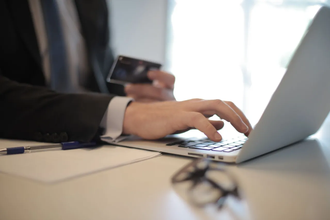 Verifying an unfamiliar card charge in online banking on a laptop