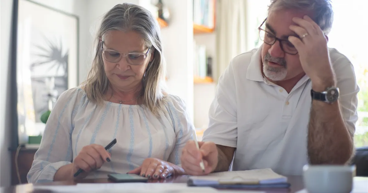 Seniors discounts Ontario: couple totalling their monthly savings at home